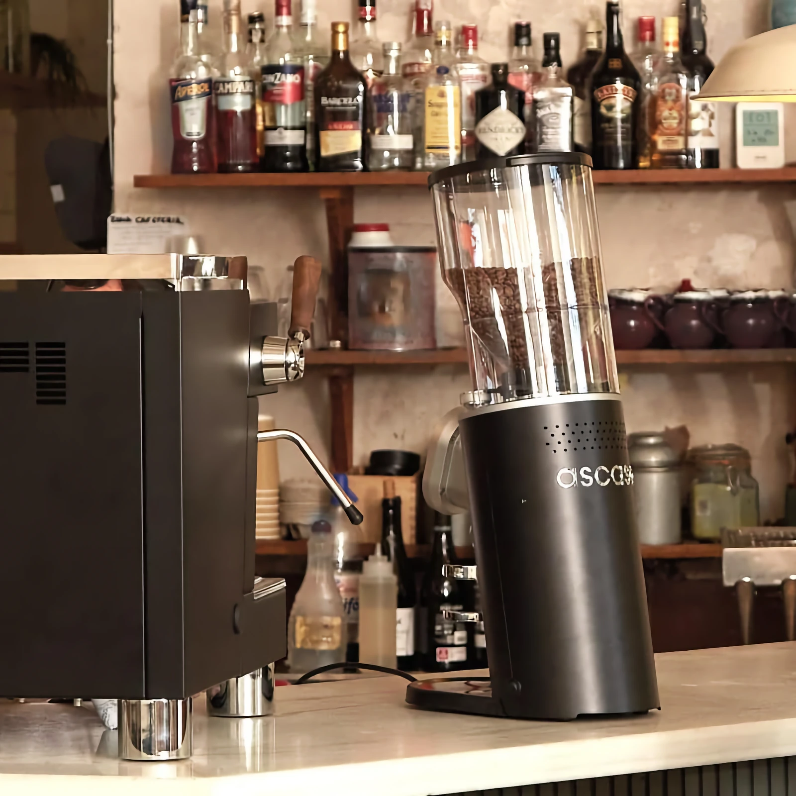 „Ascaso“ P74 on a café bar beside an espresso machine